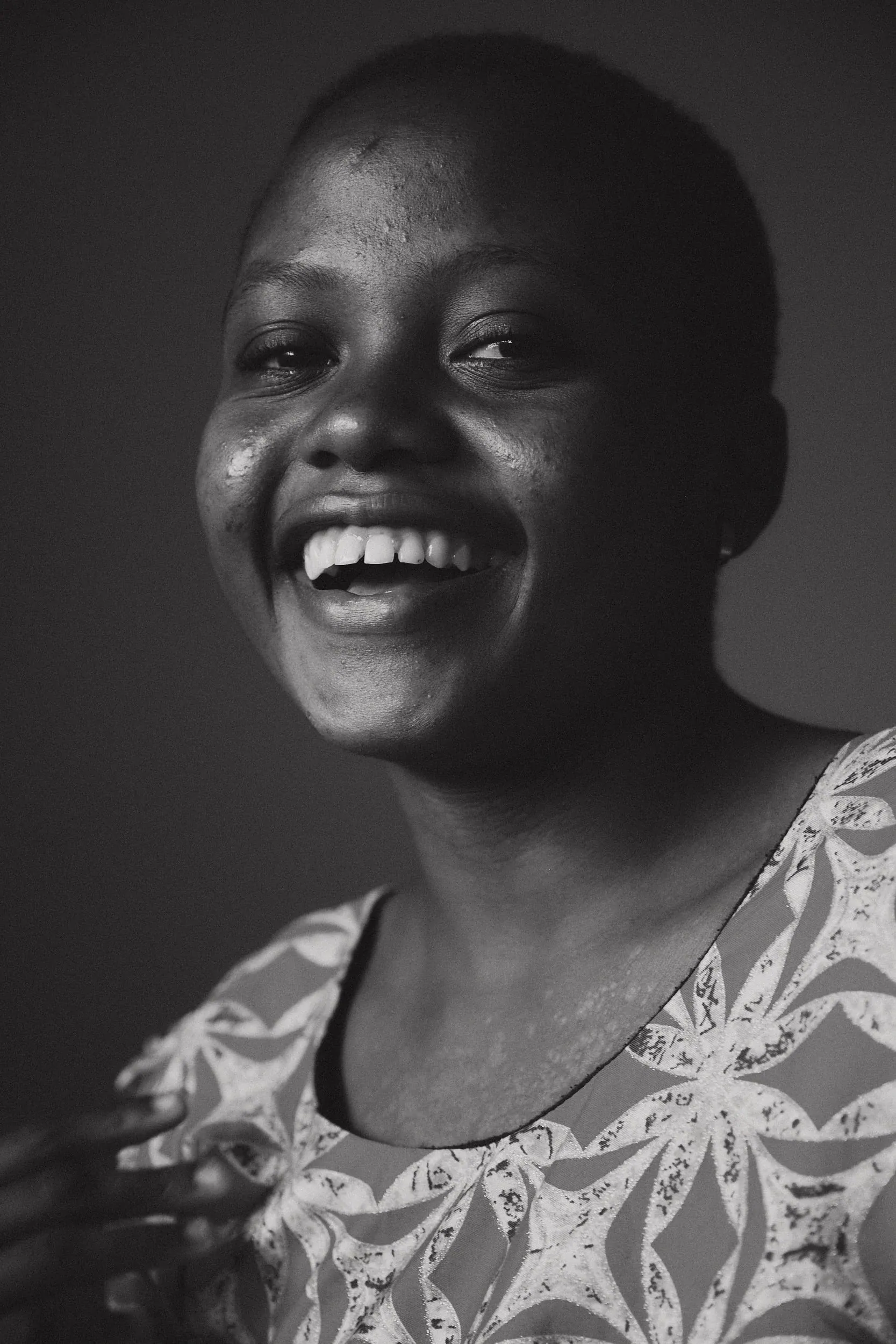 The same young woman laughing, eyes bright (black and white)