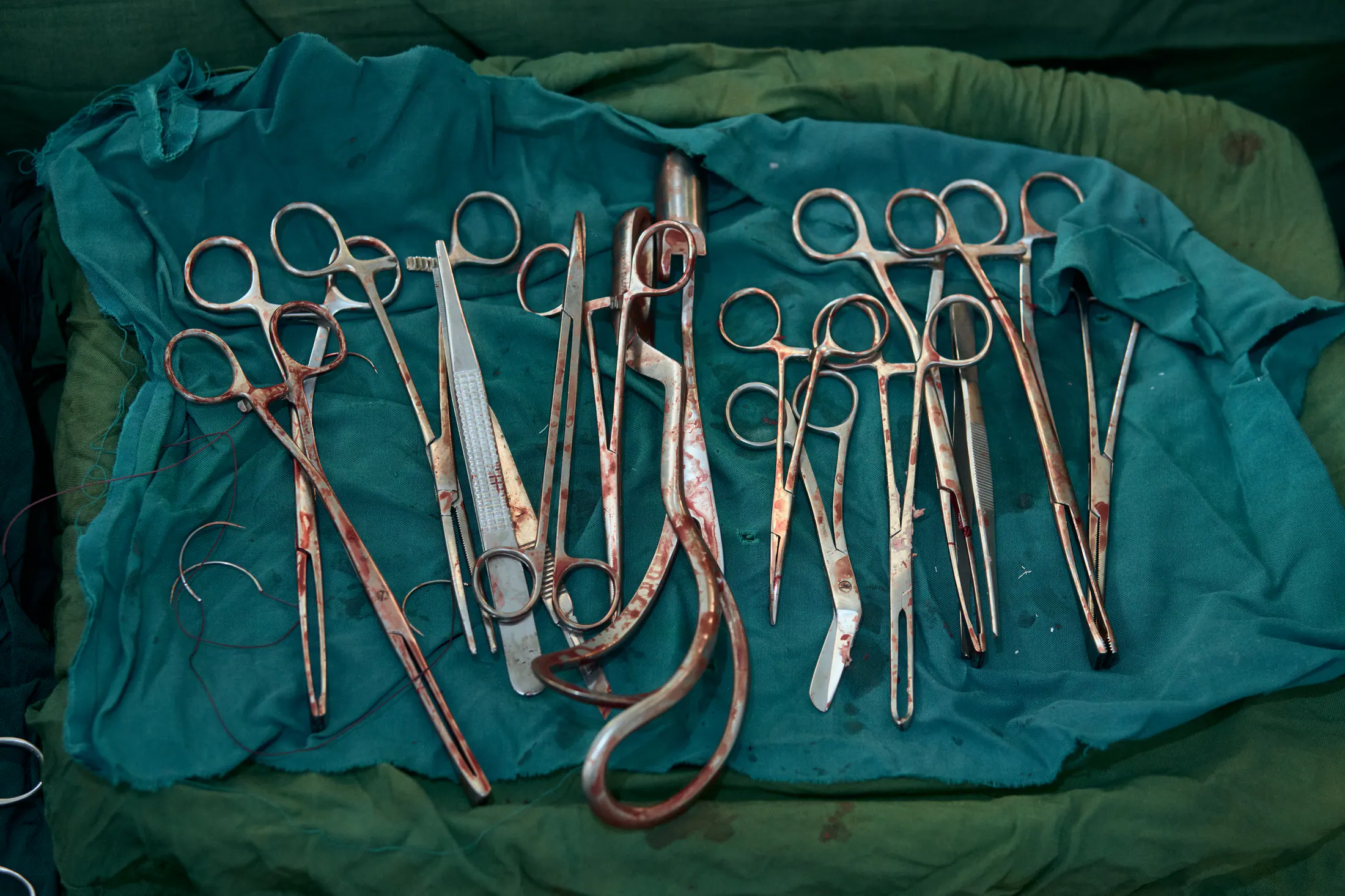 Surgical instruments laid out on green cloth