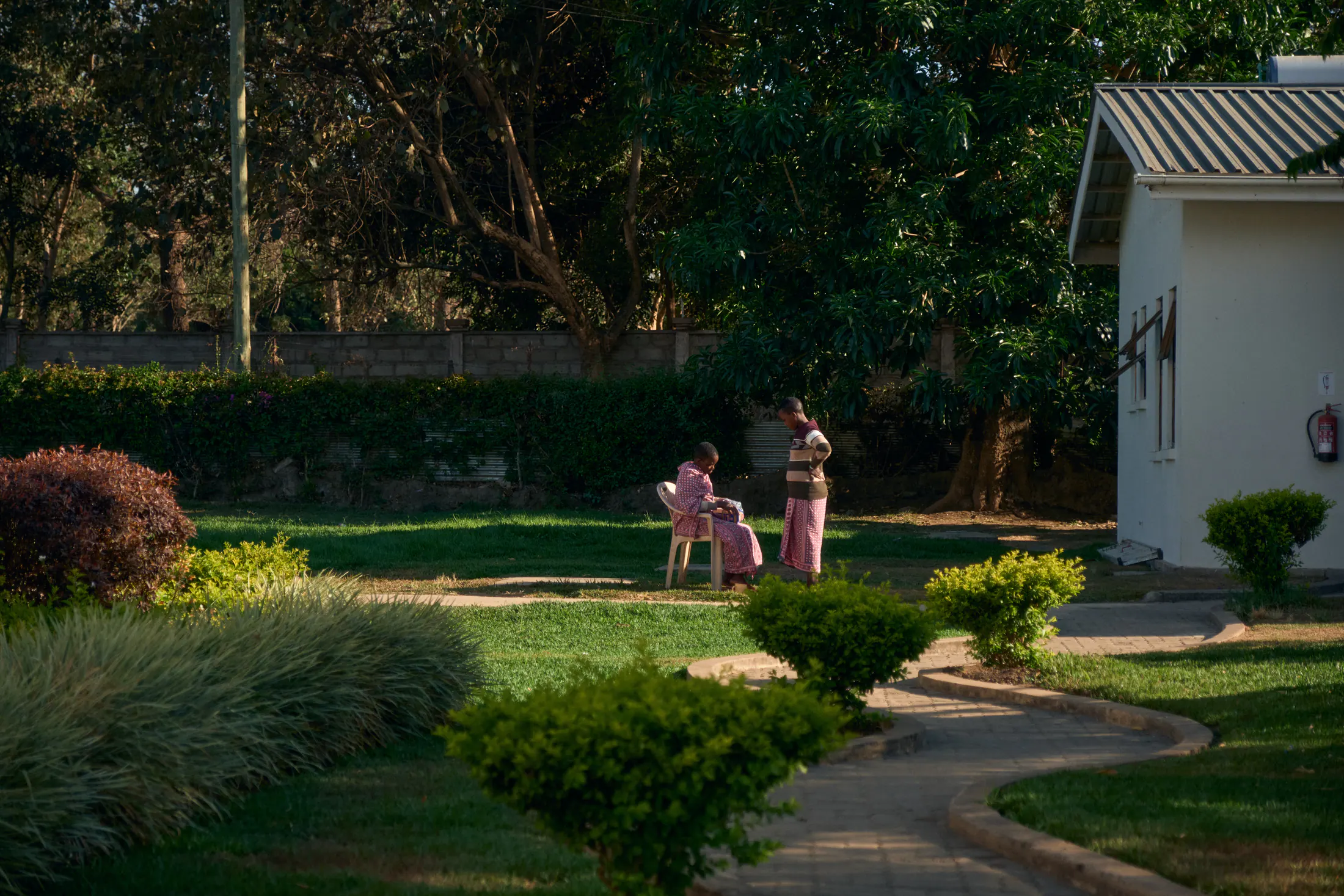 The hospital gardens, with figures walking a path between the wards
