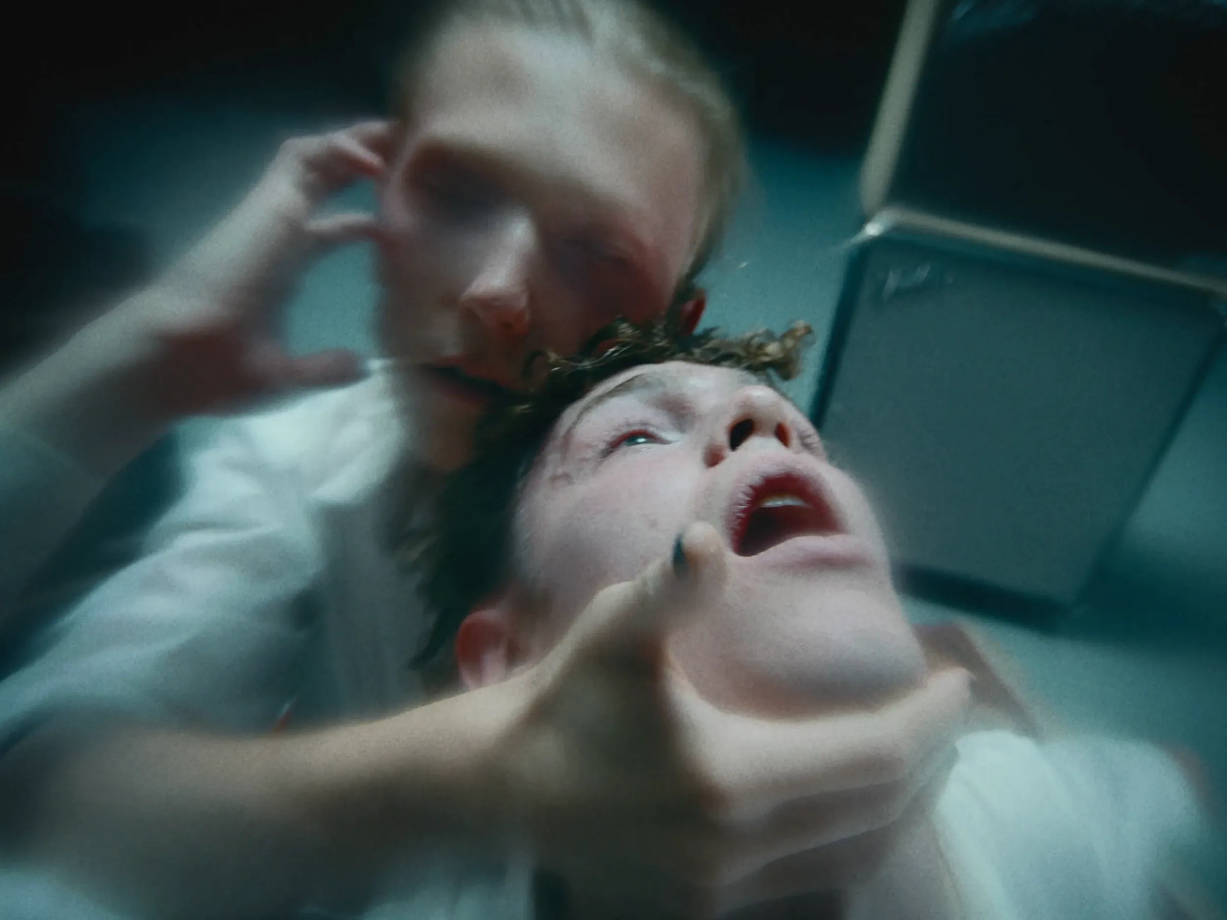 One dancer pulls back the other's head, both mid-movement