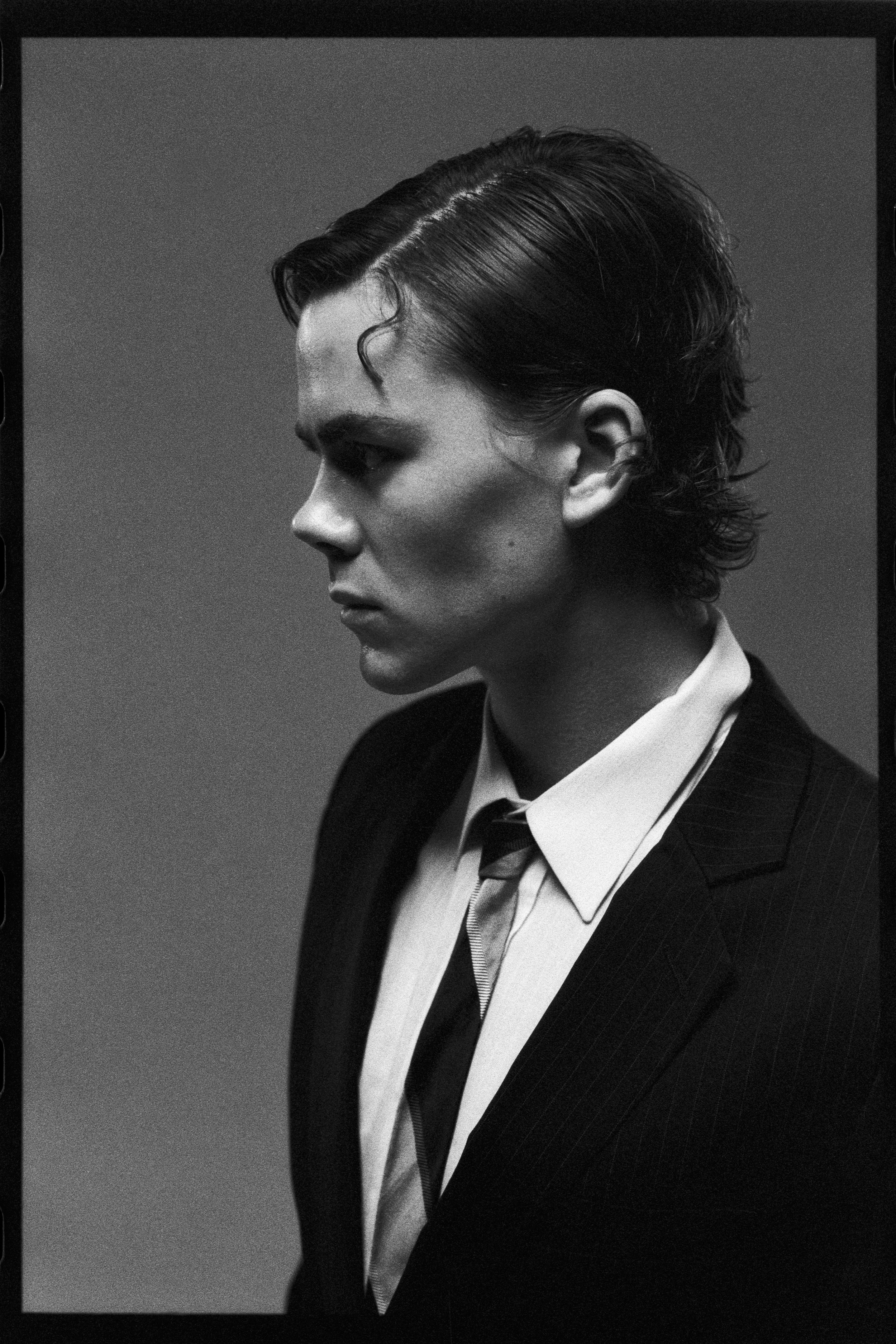 Profile portrait of the dancer in suit and tie